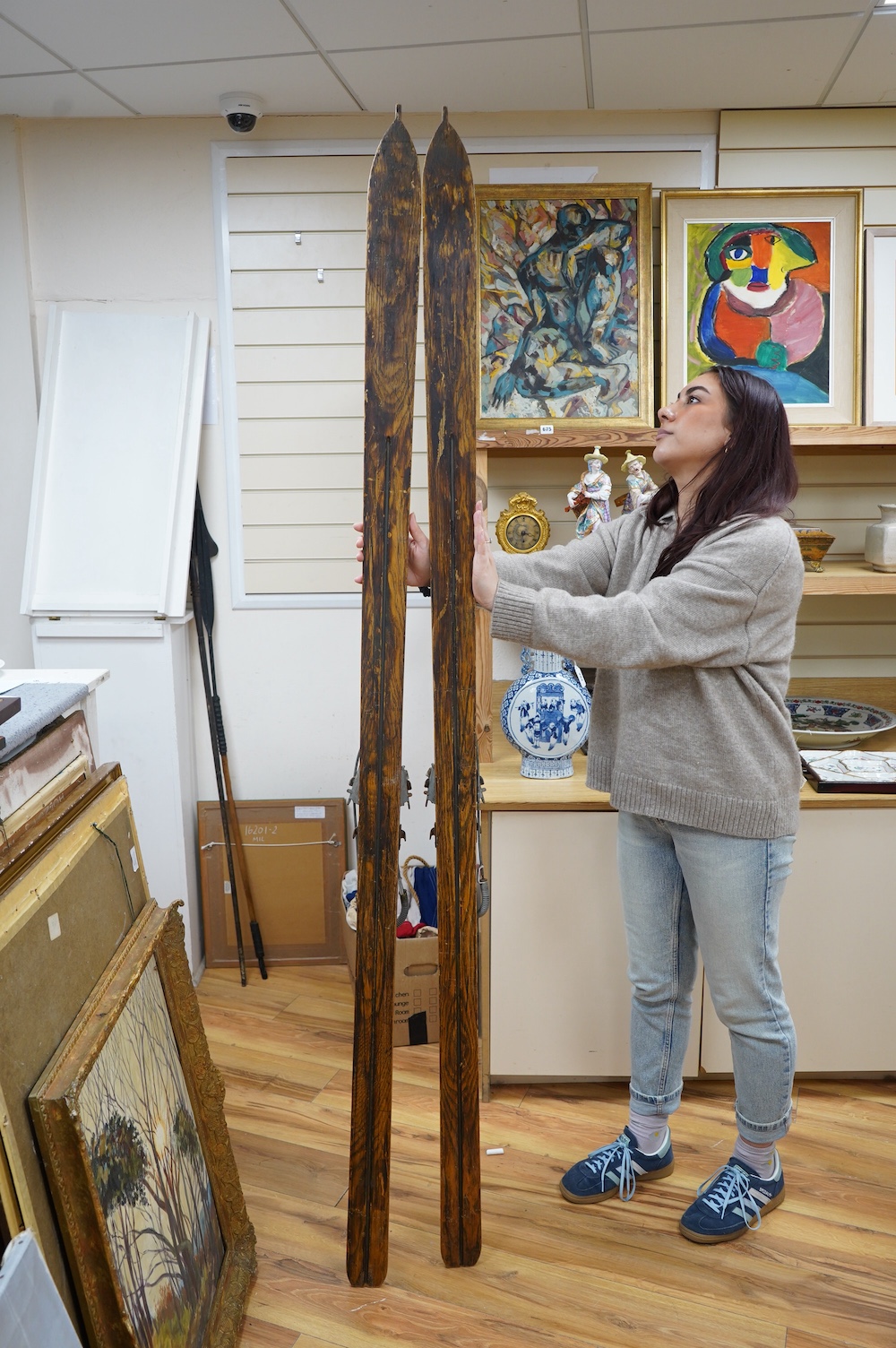 A pair of early 20th century wooden skis with Kandahar metal bindings. 207cm long. Condition - bindings rusty in places leather strapping worn in places, skis appear good but are untested